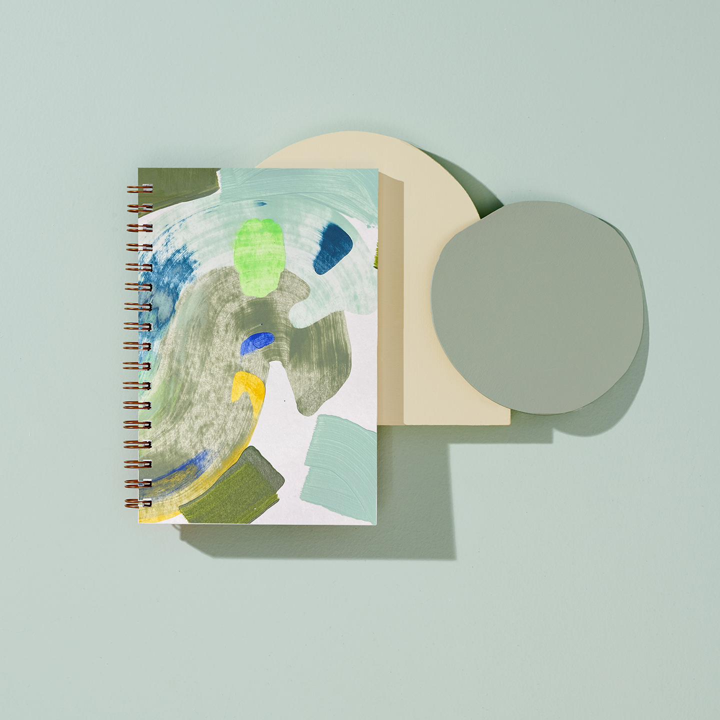 blank moglea notebook with abstract design on a light blue background