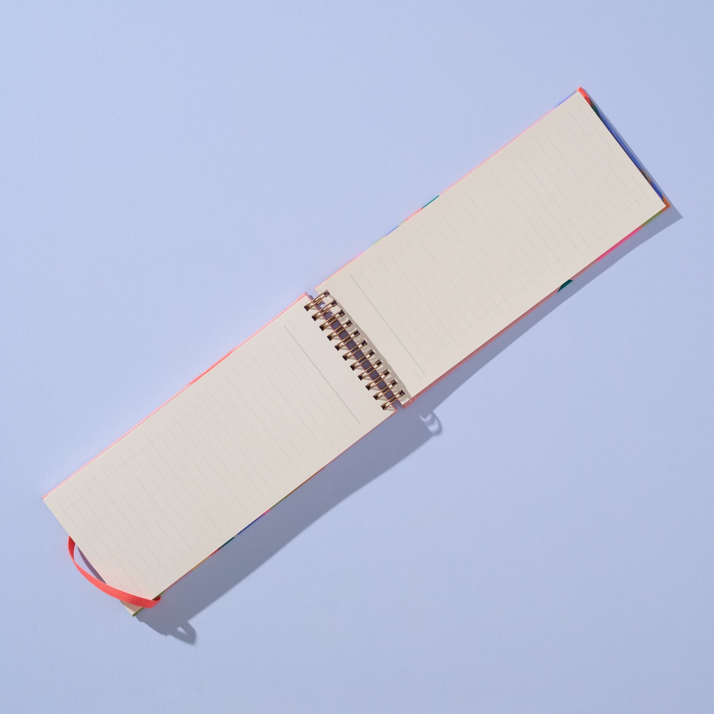 Open notebook with beige pages on a light blue background