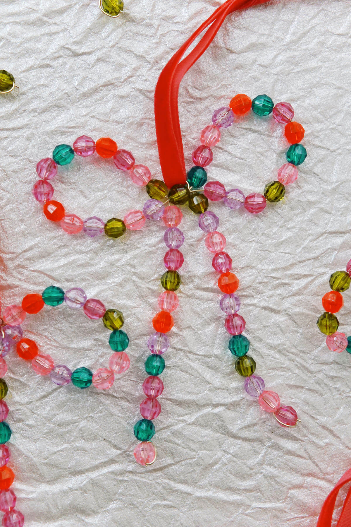 Colorful hand-beaded bow ornaments with red velvet ribbon - shop wallflower christmas