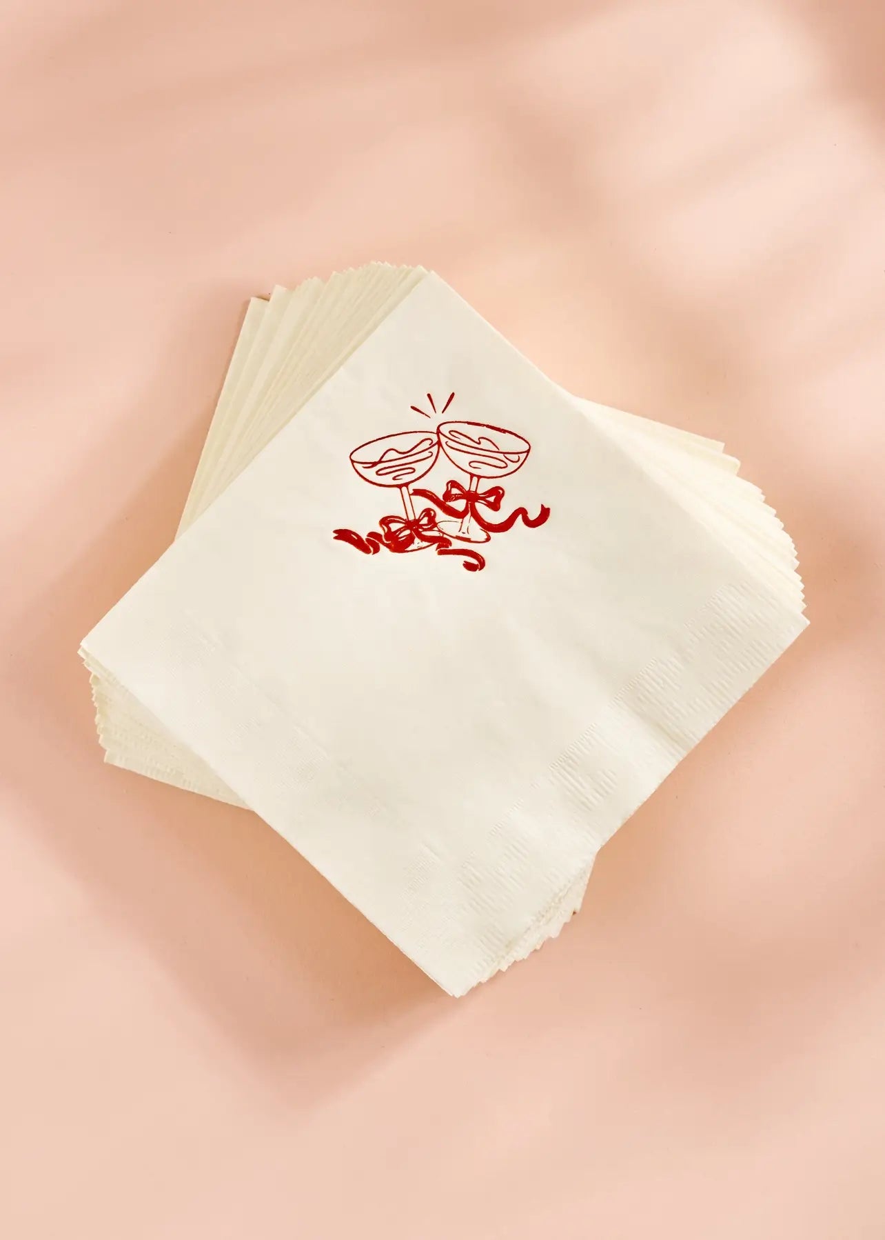 fun cocktail napkins with red champagne coupes and bows