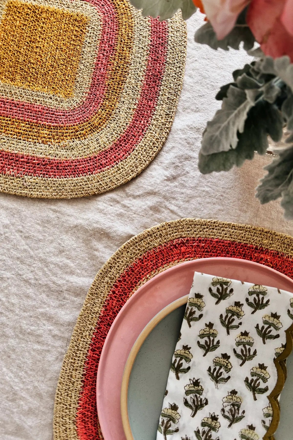 table setting with pink + yellow placemats