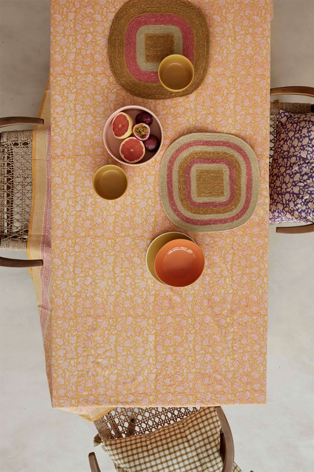 tablesetting with orange, pink, and yellow and raffia placemats
