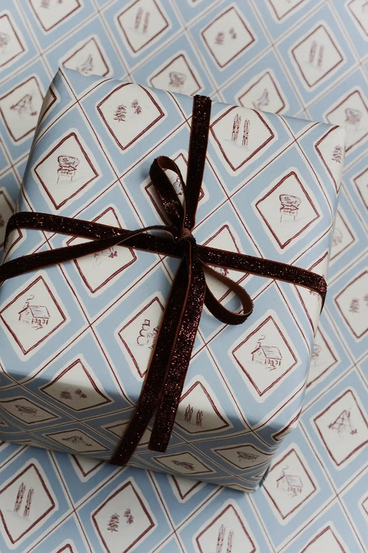 present wrapped in blue illustrated winter snow gift wrap for christmas from wallflower shop