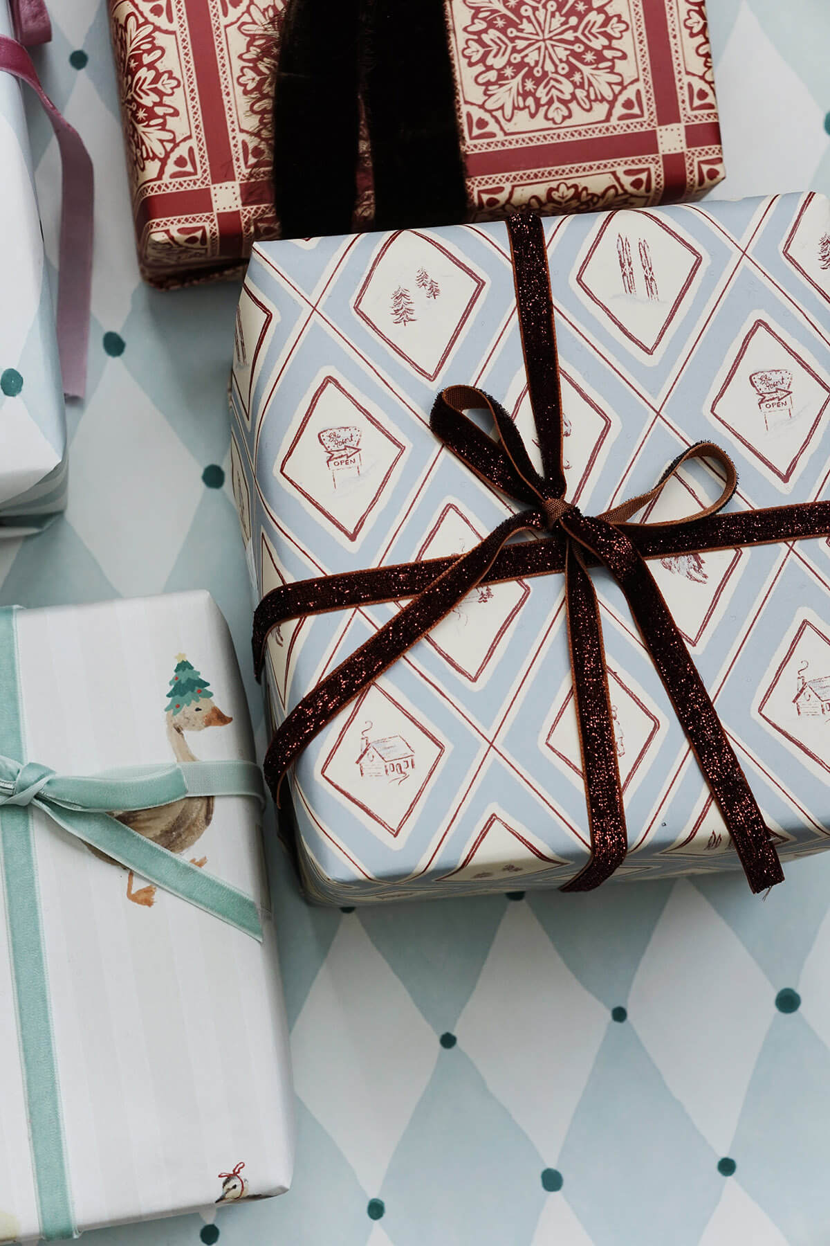 presents wrapped in blue illustrated winter snow gift wrap for christmas from wallflower shop