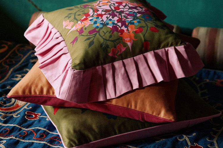 stack of decorative floral throw pillows by maximalist decorator sophie williamson design