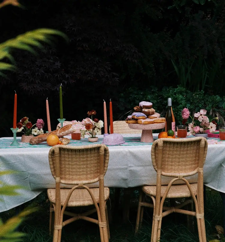 brunch outdoor table with colorful candles and donuts for spring decorating collection