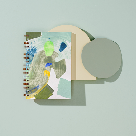 blank moglea notebook with abstract design on a light blue background