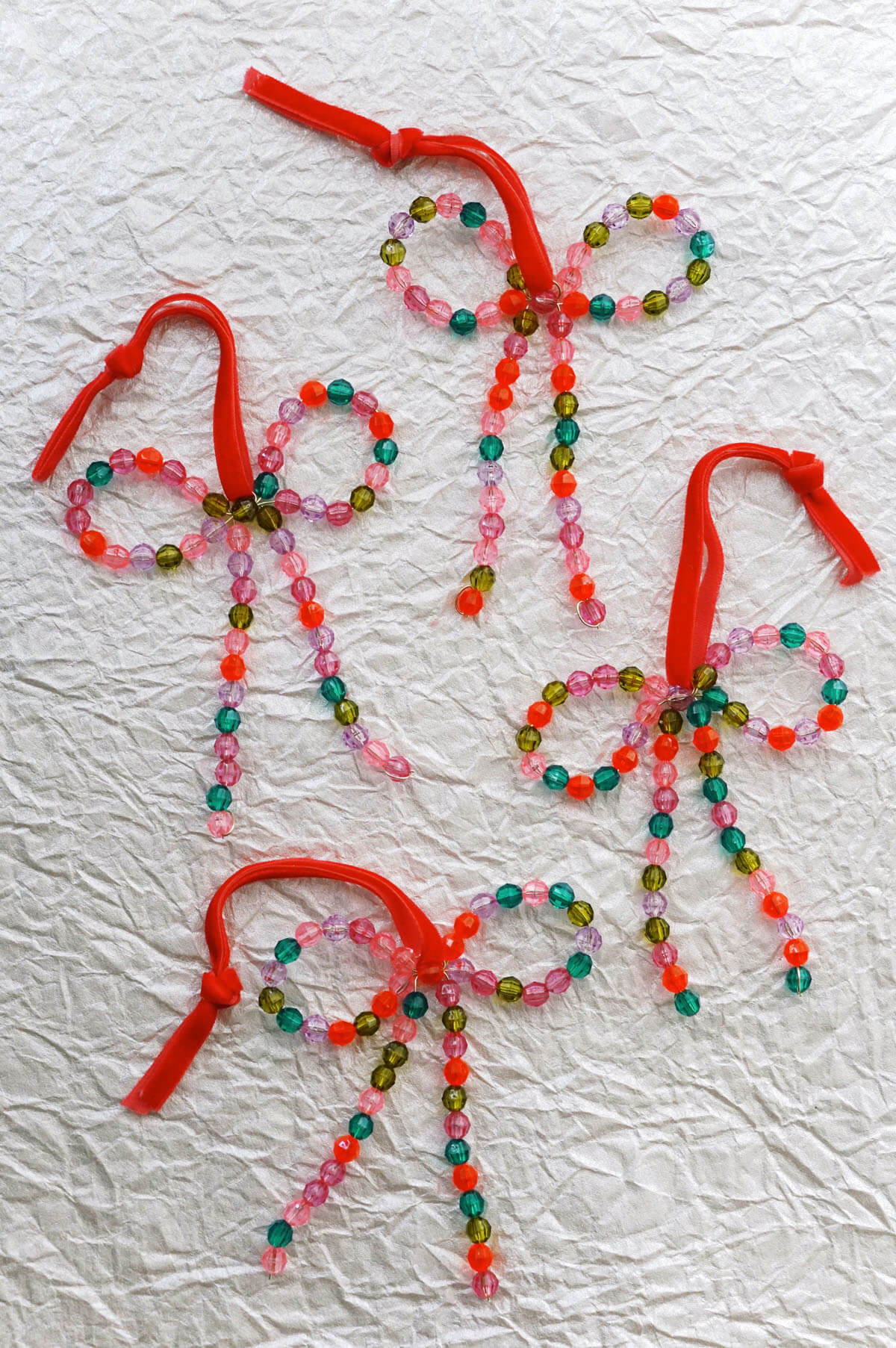 Colorful hand-beaded bow ornaments with red velvet ribbon - shop wallflower christmas