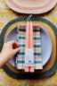 plaid dinner napkin + pink taper candles by wallflower