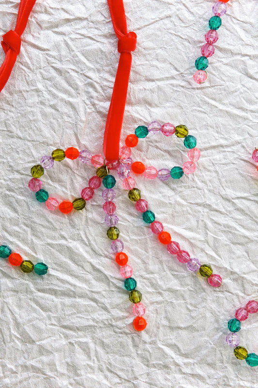 Colorful hand-beaded bow ornaments with red velvet ribbon - shop wallflower christmas