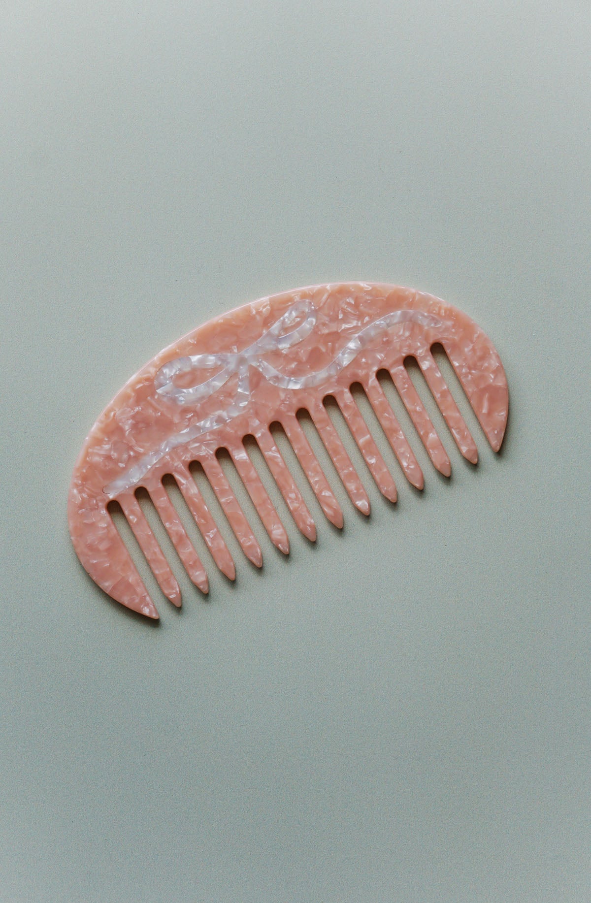 pink gua sha hair comb with bow in cellulose acetate ✿ shop small gift ideas on wallflower