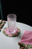 cute drink coasters and pink + green cloth napkins on a dining table