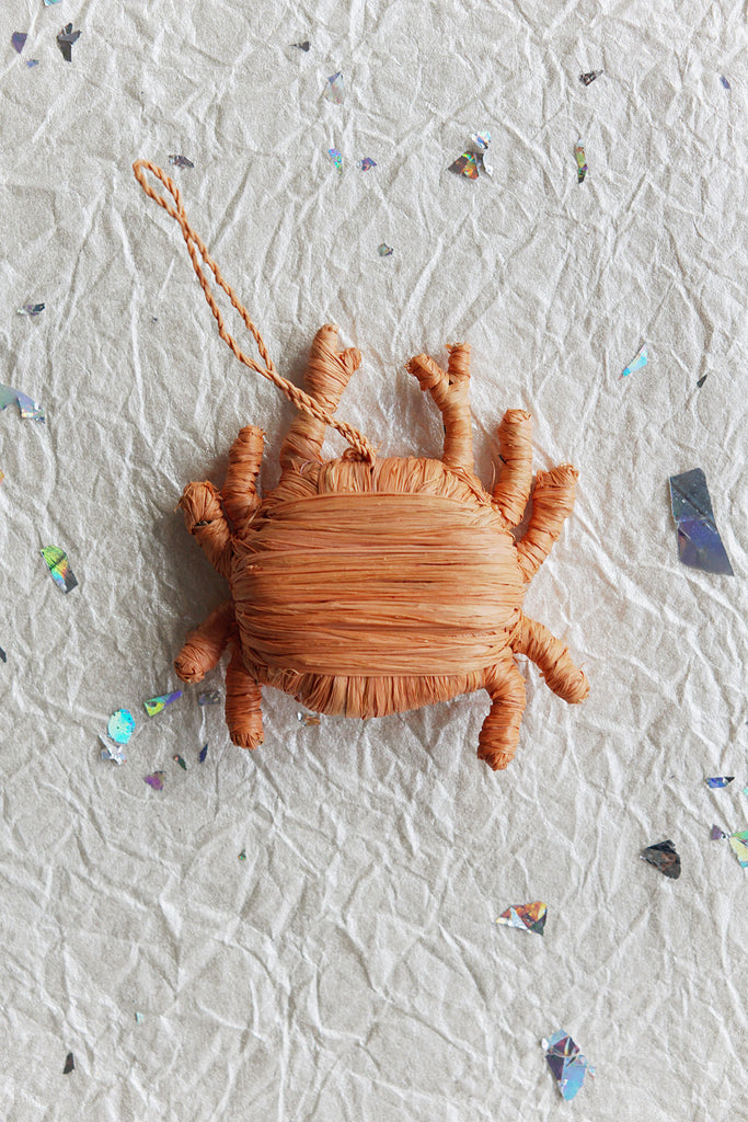 this beachy ornament is a handwoven peach crab from sisal! fair trade and handwoven in rwanda