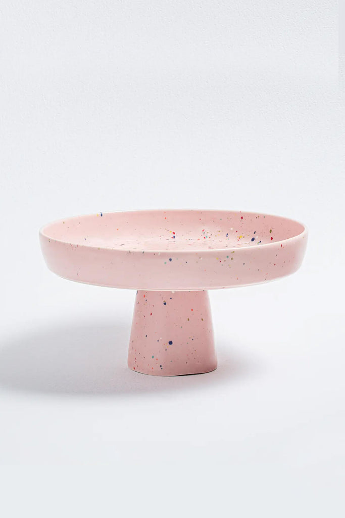 pink ceramic cake stand from egg back home with rainbow confetti paint