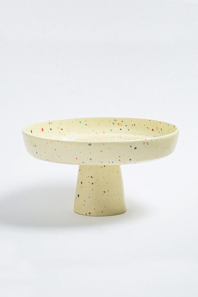 pale yellow egg back home party ceramic cake stand from wallflower