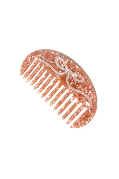 pink gua sha hair comb with bow in cellulose acetate ✿ shop small gift ideas on wallflower