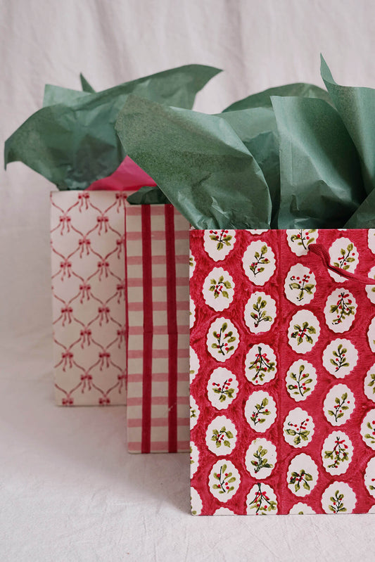 large festive christmas gift bags in red, green, and pink - hand block printed - shop holiday gifting on wallflower