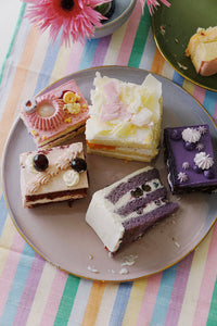 spring table with plate of colorful cake slices and archive new york maxine pastel striped table runner ✿ wallflower