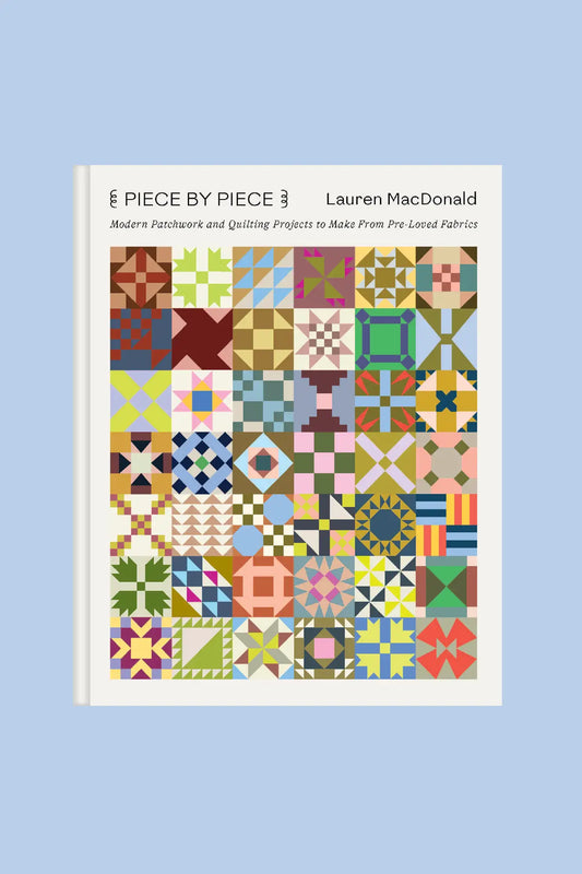 cover of 'Piece by Piece' quilt book with colorful quilt patterns on a light blue background
