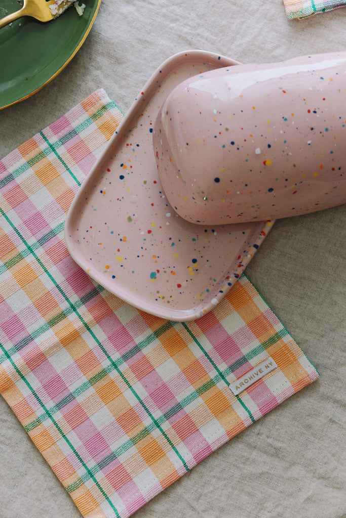 pink butter dish with colorful napkins from wallflower shop