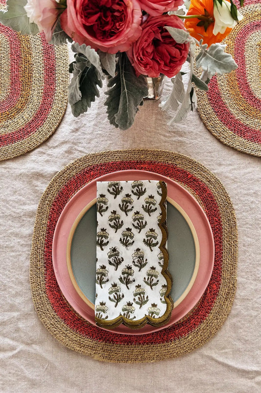 table setting with pink placemats and floral napkin