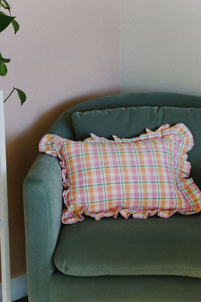 sage green accent chair with pink pastel plaid ruffle pillow by archive new york