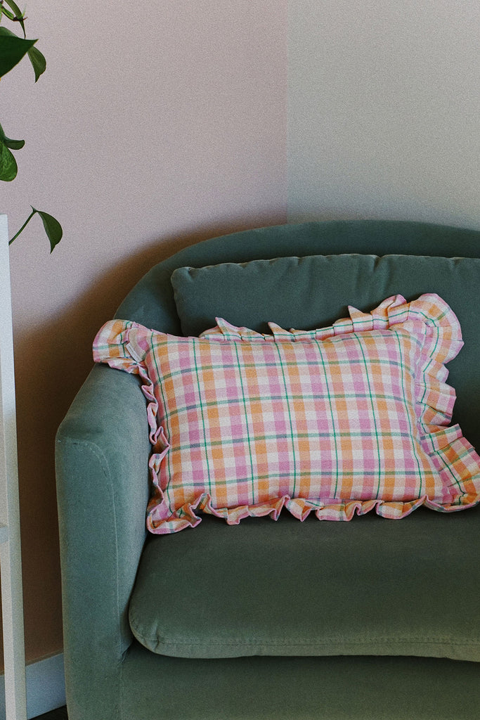 sage green accent chair with pink pastel plaid ruffle pillow by archive new york