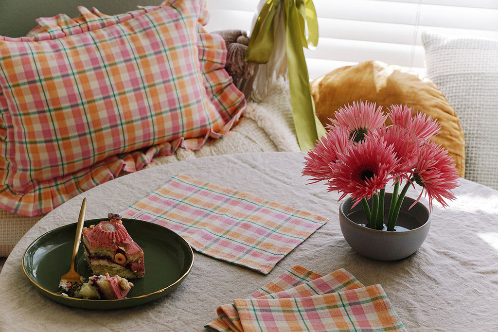 spring dining nook with plaid napkins and pillows by archive new york