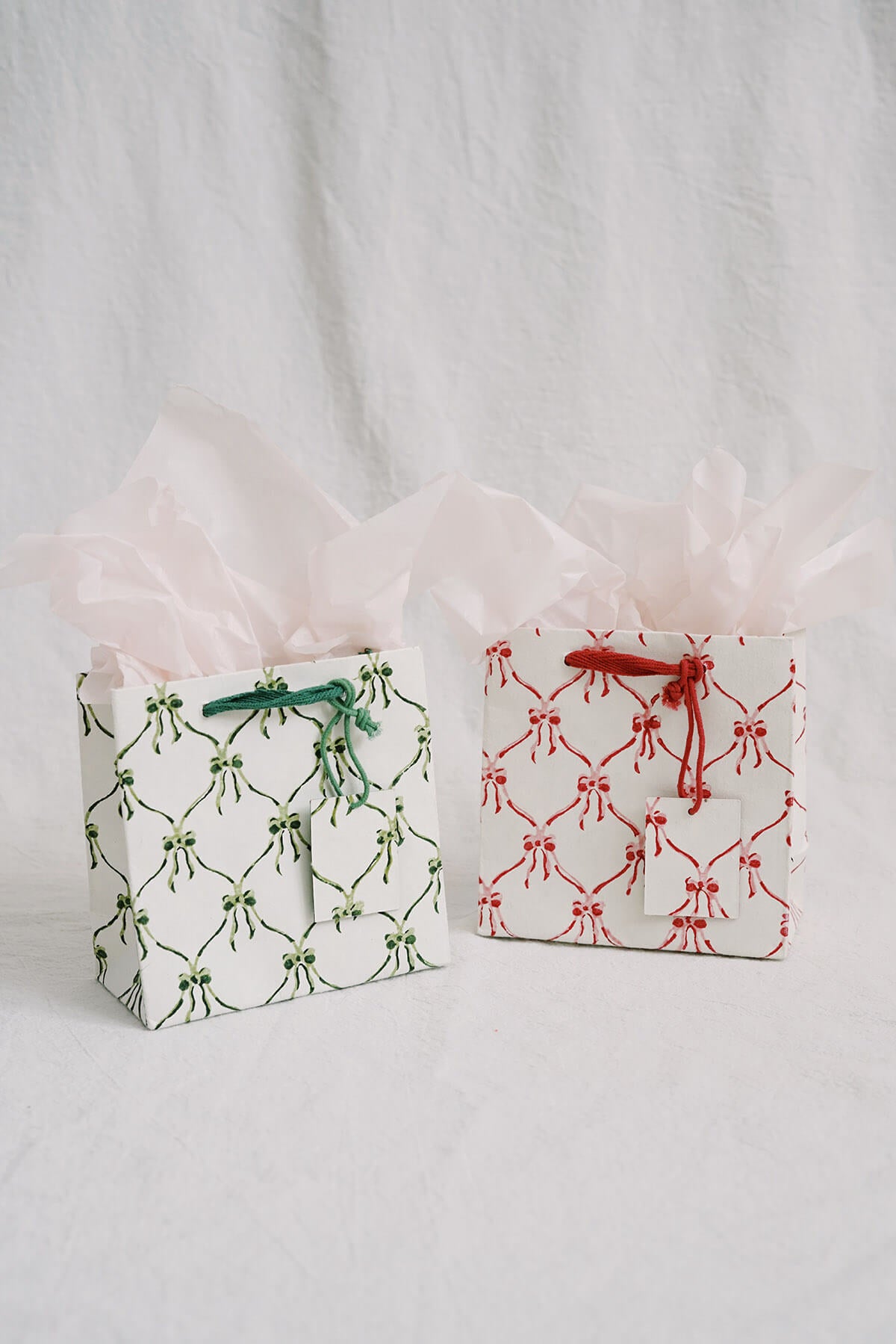 small eco friendly christmas gift bags with bows in green and red - hand block printed recycled gift bags