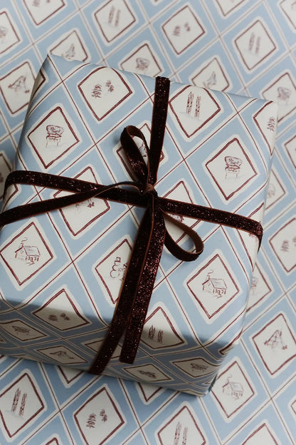 present wrapped in blue illustrated winter snow gift wrap for christmas from wallflower shop