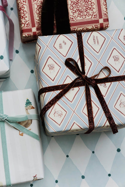 presents wrapped in blue illustrated winter snow gift wrap for christmas from wallflower shop