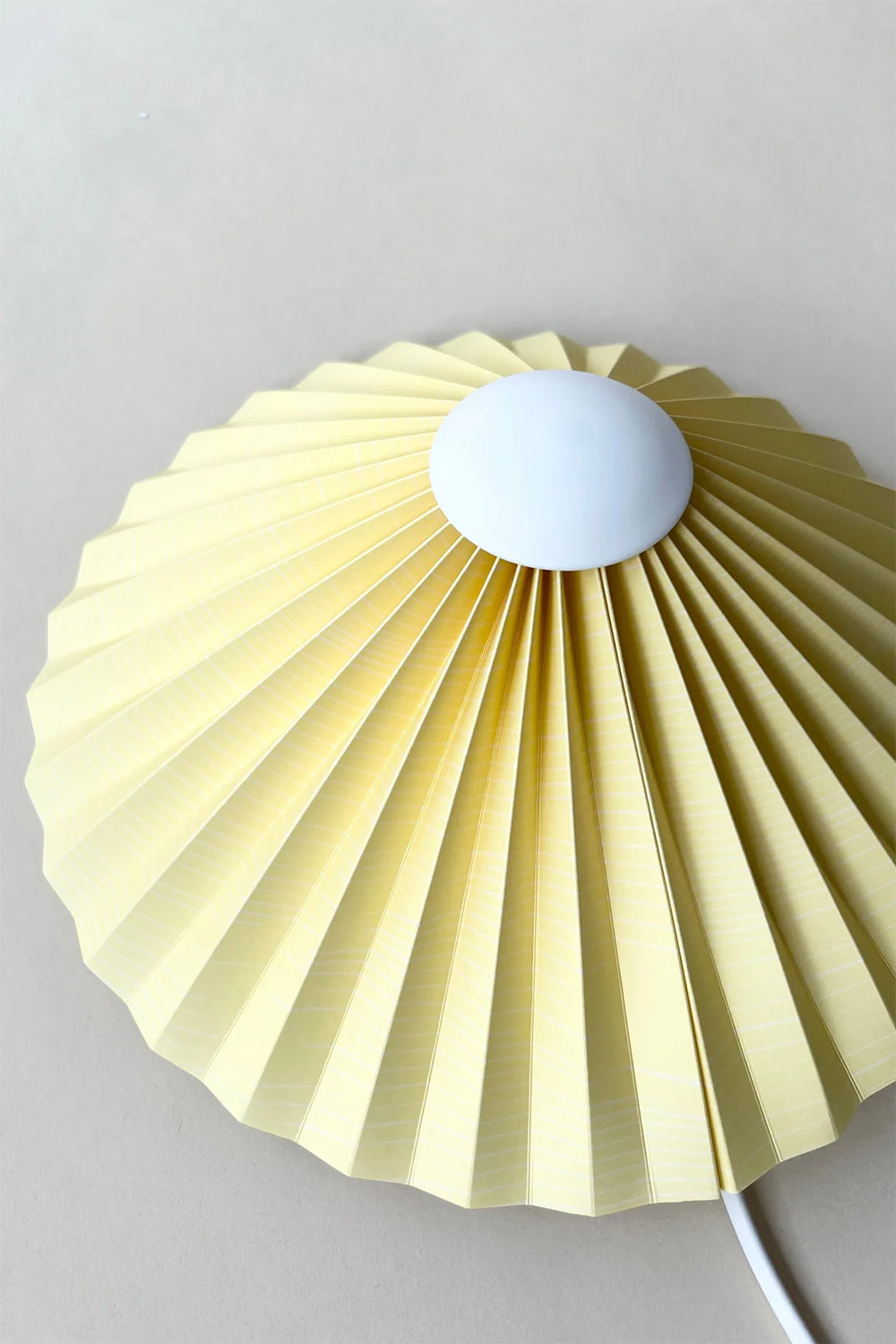 pastel yellow pleated wall lamp by shady business