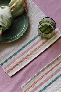 pink place settings with woven placemats