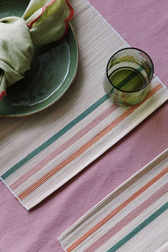 pink place settings with woven placemats